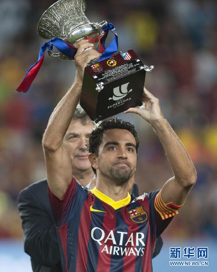  Xavi lifts the trophy.