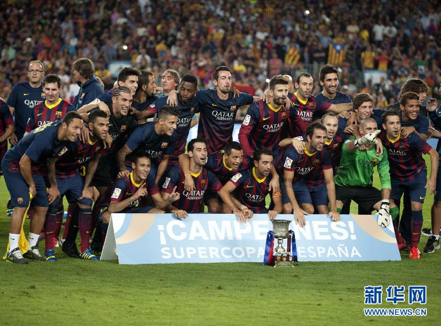 Barcelona players pose with the trophy. 