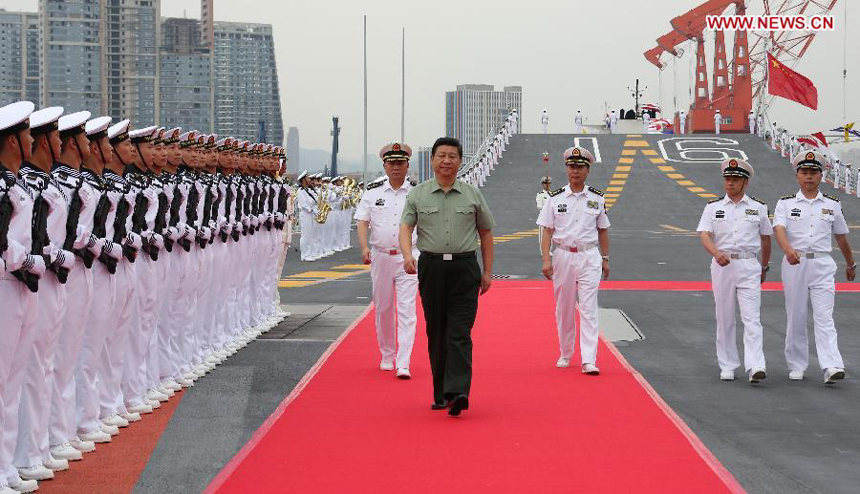 Chinese President Xi Jinping (C front), who is also the chairman of the Central Military Commission and general secretary of the Communist Party of China Central Committee, reviews an honor guard on the aircraft carrier, the Liaoning, in northeast China&apos;s Liaoning Province, Aug. 28, 2013. Xi visited the Shenyang military theater of operations before attending the Saturday opening ceremony of the 12th National Games in Shenyang. 