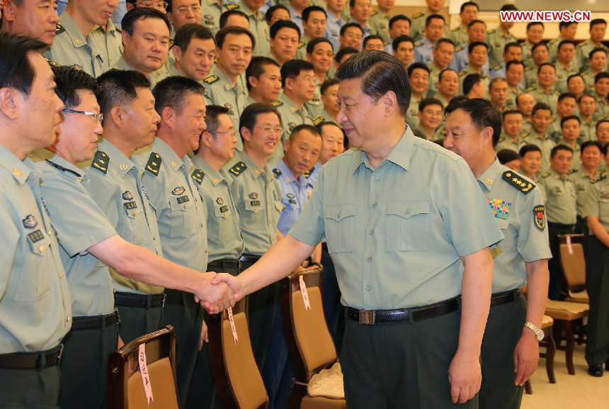 Chinese President Xi Jinping (R, front), who is also the chairman of the Central Military Commission and general secretary of the Communist Party of China Central Committee, shakes hands with senior officers from Shenyang military theater of operations in northeast China&apos;s Liaoning Province, Aug. 29, 2013. Xi visited the Shenyang military theater of operations before attending the Saturday opening ceremony of the 12th National Games in Shenyang. 