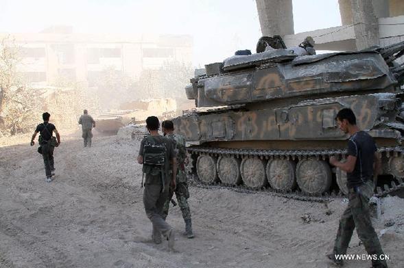 Syrian soldiers are seen at the battlefront of Jobar, near the capital of Damascus, on Aug. 24, 2013. Some Syrian soldiers on Saturday suffered suffocation after rebel militants released chemical substance around their hideouts near Damascus, the state-TV reported. [Bassem Tellawi/Xinhua]