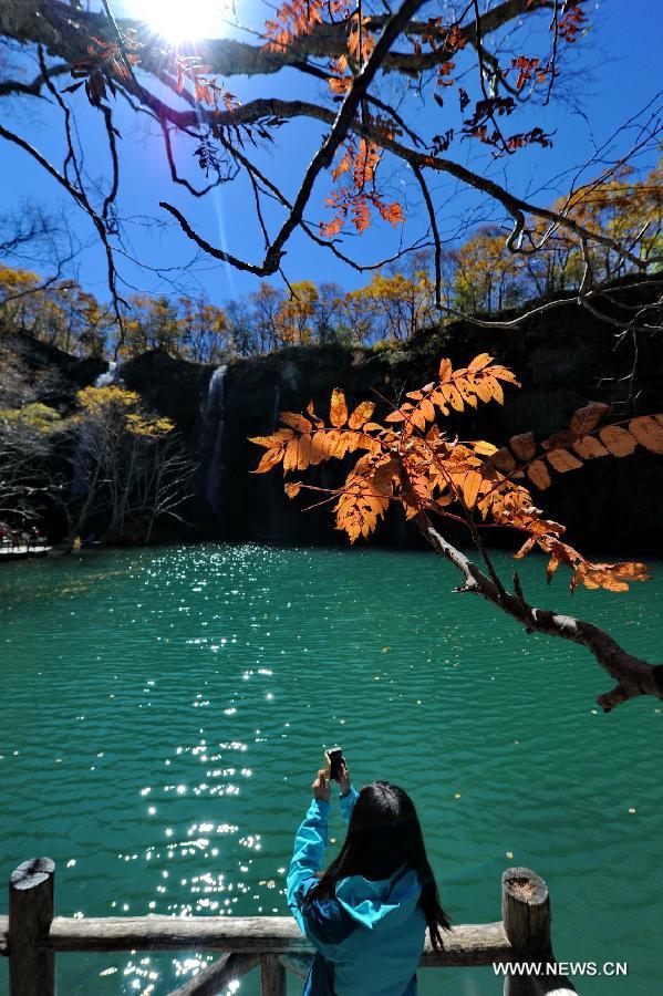 A tourist takes photo on the Changbai Mountain in northeast China's Jilin Province, Sept. 15, 2013