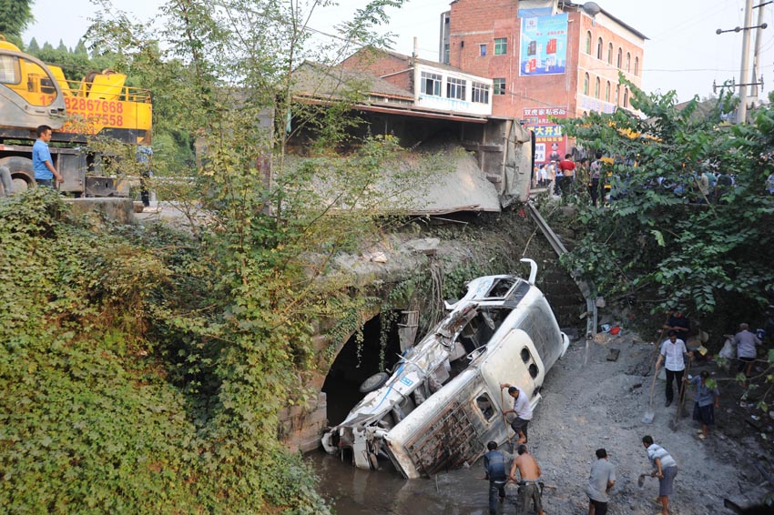 Photo taken on Sept. 15, 2013 shows the site where a road accident occurred in Zhenwu Village, Dazhou City, southwest China&apos;s Sichuan Province. Sixteen people, including 11 students, have been confirmed dead in the road accident, when a passenger bus collided with a truck, and then fell off a bridge. 