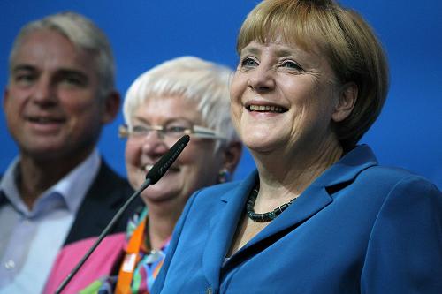 German Chancellor and leader of the Christian Democratic Union(CDU) Angela Merkel and her partners celebrate afer first exit polls in the German general election at the CDU party headquarters in Berlin September 22, 2013. [Xinhua]