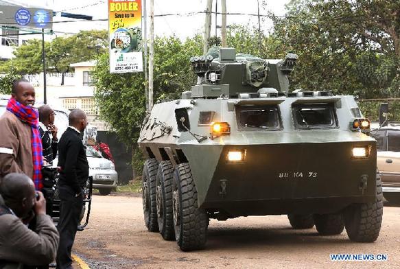A armored vehicle drives into security area near the Westgate shopping center in Nairobi, Kenya, Sept. 24, 2013. Kenyan security forces continued its operation on Tuesday inside the mall where 62 people were killed by gunmen since Saturday. [Zhang Chen/Xinhua]