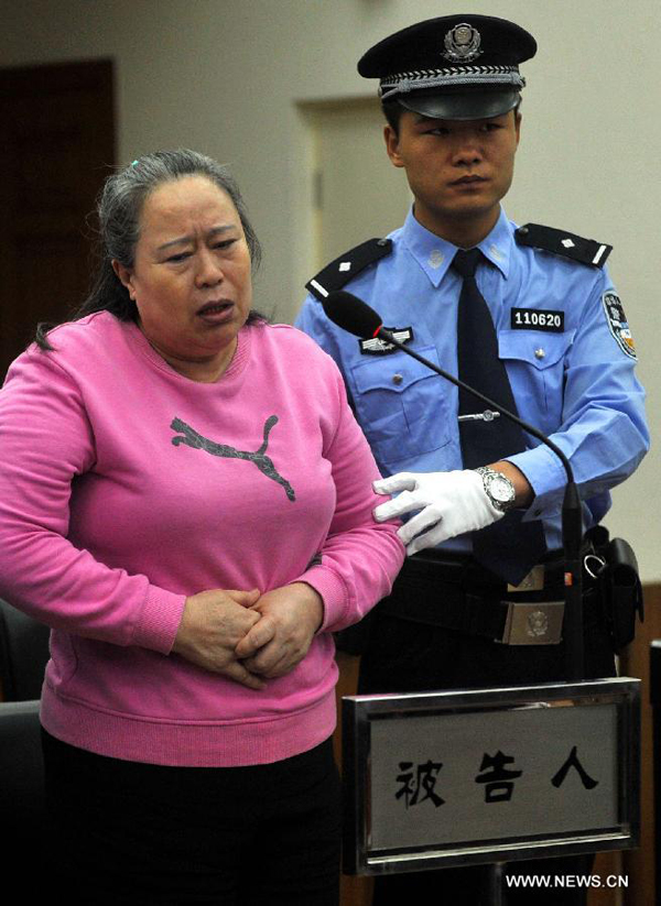 Ding Yuxin, once called Ding Shumiao, a bussinesswoman who was involved in the corruption case of former railway minister Liu Zhijun, is on trial at the No. 2 Beijing Municipal Intermediate People's Court in Beijing, capital of China, Sept. 24, 2013. 