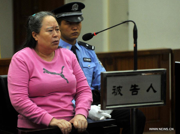 Ding Yuxin, once called Ding Shumiao, a bussinesswoman who was involved in the corruption case of former railway minister Liu Zhijun, is on trial at the No. 2 Beijing Municipal Intermediate People's Court in Beijing, capital of China, Sept. 24, 2013. 