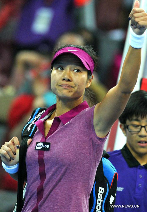 Li Na of China gestures after the women's singles quarterfinal match against Petra Kvitova of Czech Republic at the China Open tennis tournament in Beijing, Oct. 4, 2013. Li lost the match 1-2. [Xinhua/Gong Lei]