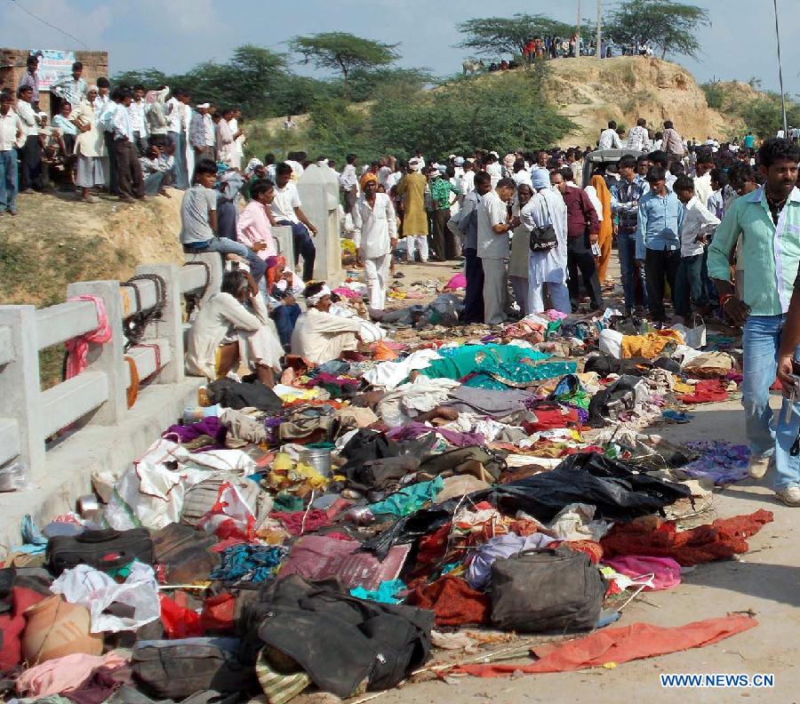 Bodies of stampede victims lie on a bridge across a river in Datia district in Madhya Pradesh state, India, Oct. 13, 2013. At least 50 people were killed and more than 100 others injured in a stampede in the central Indian state of Madhya Pradesh Sunday, a senior police official said. 