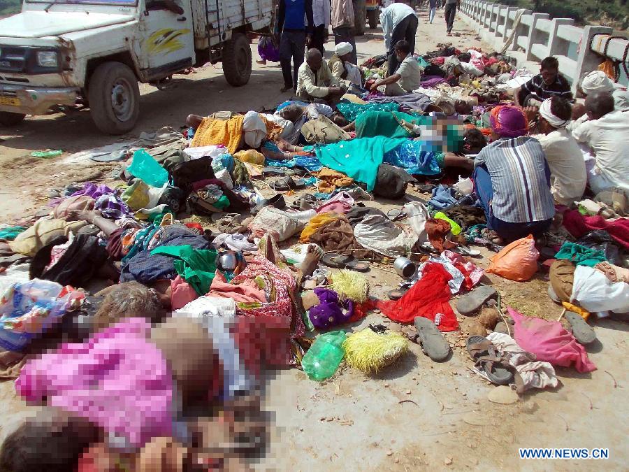 Bodies of stampede victims lie on a bridge across a river in Datia district in Madhya Pradesh state, India, Oct. 13, 2013. At least 50 people were killed and more than 100 others injured in a stampede in the central Indian state of Madhya Pradesh Sunday, a senior police official said. 