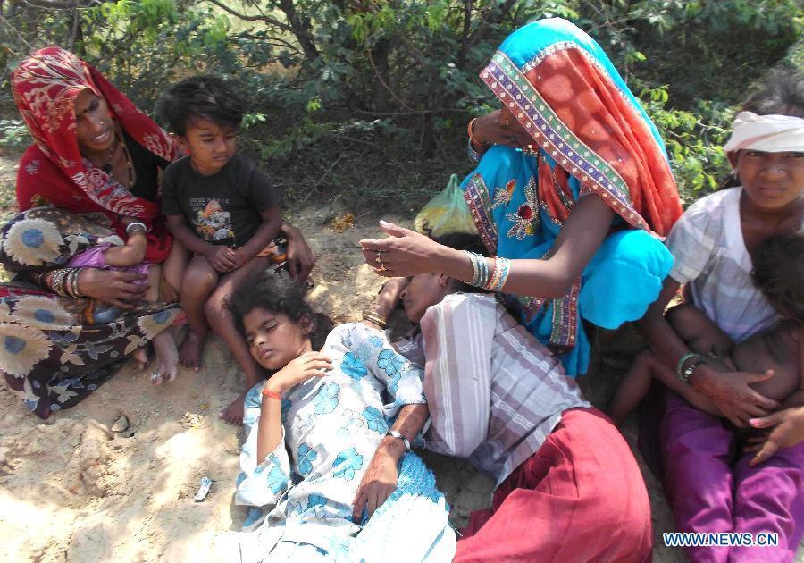 Injured people lie on a road in Datia district in Madhya Pradesh state, India, Oct. 13, 2013. At least 50 people were killed and more than 100 others injured in a stampede in the central Indian state of Madhya Pradesh Sunday, a senior police official said.