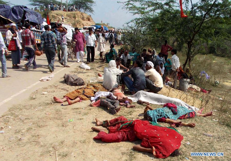 Bodies of stampede victims lie on a road in Datia district in Madhya Pradesh state, India, Oct. 13, 2013. At least 50 people were killed and more than 100 others injured in a stampede in the central Indian state of Madhya Pradesh Sunday, a senior police official said. 