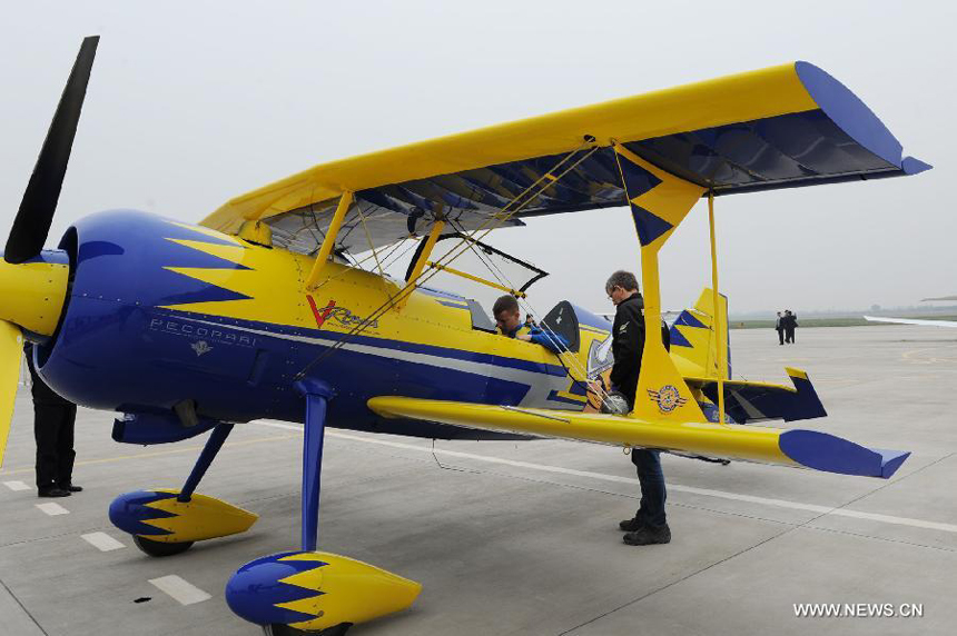 Members of a Swedish aerobatic team talk after their trial flight at the Neifu Airport in Pucheng, northwest China&apos;s Shaanxi Province, Oct. 16, 2013. The China International General Aviation Convention 2013 will open in the capital city of Xi&apos;an on Oct. 17, and the aerobatics performance will be staged at the Neifu Airport.