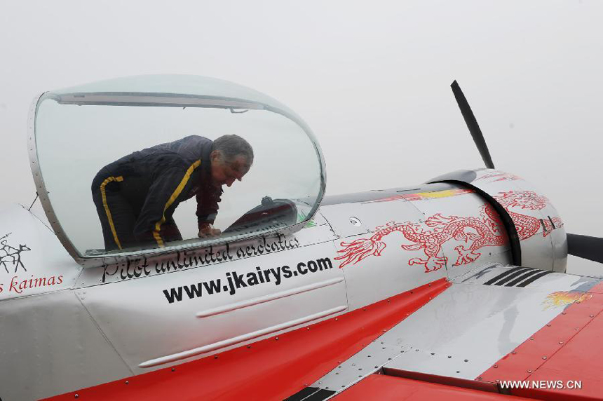 A member of a Lithuanian aerobatic team prepares his trial flight at the Neifu Airport in Pucheng, northwest China&apos;s Shaanxi Province, Oct. 16, 2013. The China International General Aviation Convention 2013 will open in the capital city of Xi&apos;an on Oct. 17, and the aerobatics performance will be staged at the Neifu Airport. 