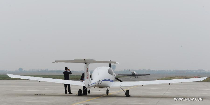 Members of a Swedish aerobatic team talk after their trial flight at the Neifu Airport in Pucheng, northwest China&apos;s Shaanxi Province, Oct. 16, 2013. The China International General Aviation Convention 2013 will open in the capital city of Xi&apos;an on Oct. 17, and the aerobatics performance will be staged at the Neifu Airport.