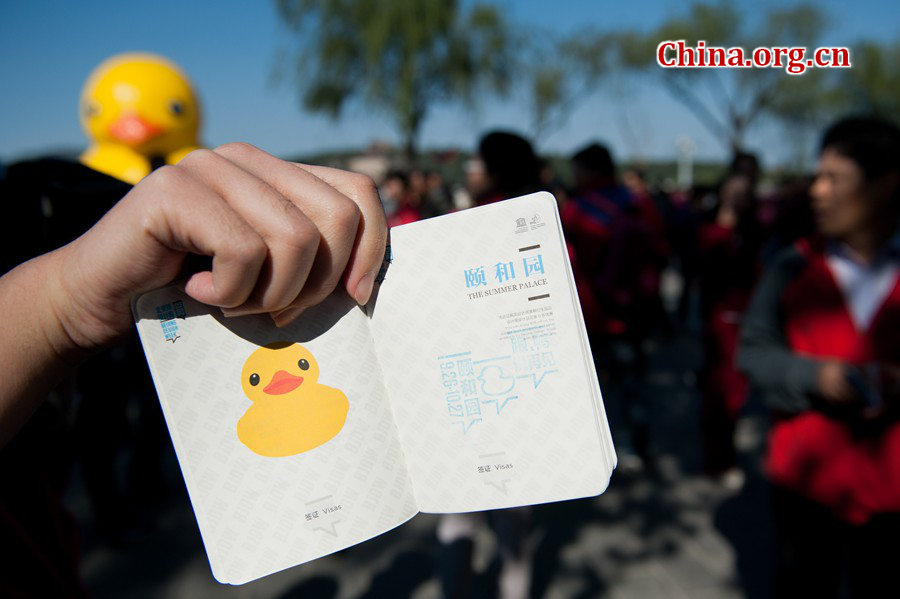 A visitor shows his Rubber Duck souvenir stamp on his Rbber Duck Passport the Summer Palace in Beijing on Sunday. [Photo / Chen Boyuan / China.org.cn]