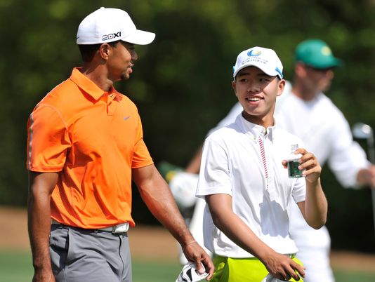 Tiger Woods of the US (L) and Guan Tianlang of China talked as they walked down the fairway on the eleventh hole during the first practice round of the 2013 Masters Tournament at the Augusta National Golf Club in Augusta, Georgia, USA, 08 April 2013.