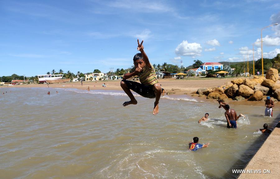 A boy jumps into the sea at the port of Coro, Venezuela. 