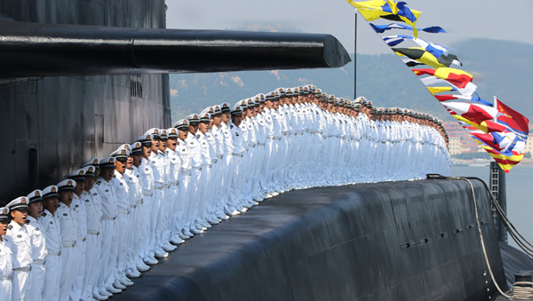 Sailors stand at attention on the nuclear submarine, stationed at the Qingdao base. Provided to China Daily