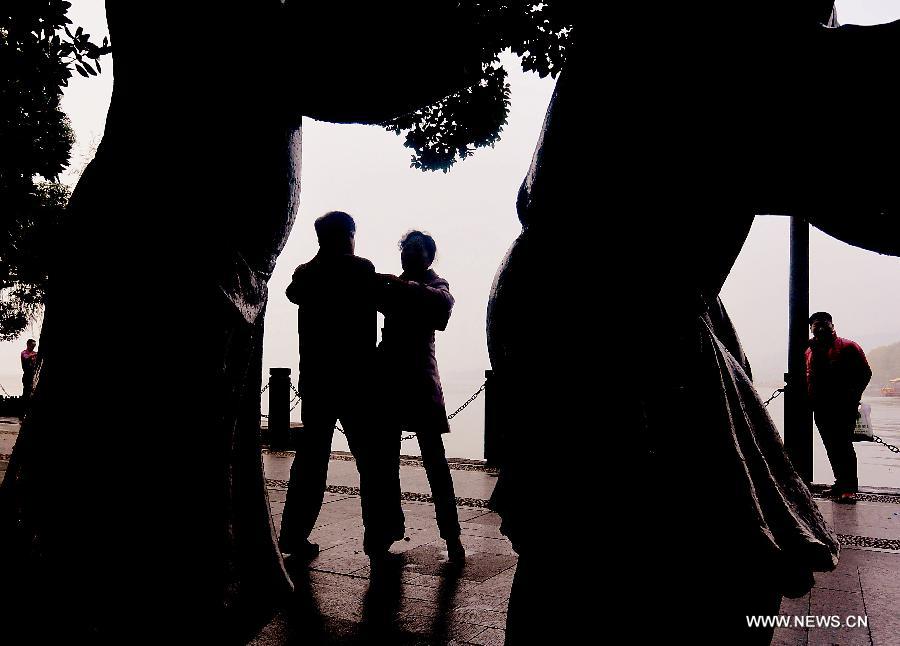 People dance by the West Lake in Hangzhou, capital of east China's Zhejiang Province, Nov. 4, 2013