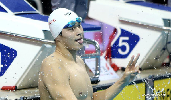 Sun Yang of Zhejiang celebrates after winning the men's 200m freestyle final of the 12th Chinese National Games in Shenyang, northeast China's Liaoning Province, Sept. 6, 2013. Sun Yang won the gold and set a new Asian record with a time of 1 minute 44.47 seconds. [Xinhua File Photo]