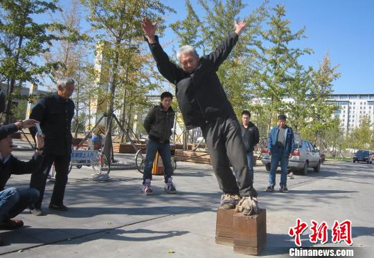 Zhang Fuxing, 51, a resident of Fengnan District in Tangshan City practices daily exercises in a pair of iron shoes which weigh 405 kg, about seven times his own weight.