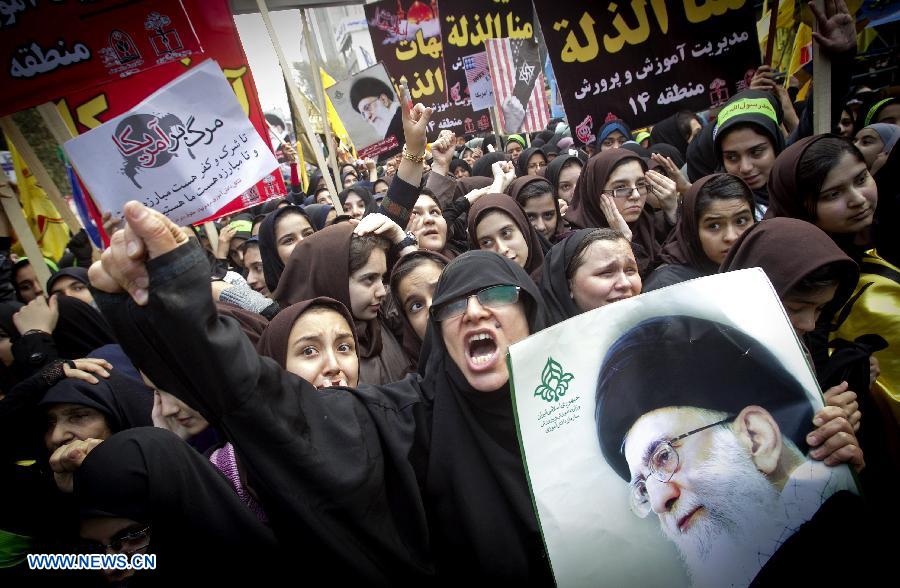 Iranian demonstrators shout slogans during a rally marking the 34th anniversary of the seizure of the U.S. Embassy outside the former U.S. embassy in downtown Tehran, capital of Iran, on Nov. 4, 2013. Tens of thousands of Iranians held demonstrations on Monday across the country to mark the 34th anniversary of the seizure of the U.S. embassy in Tehran. 