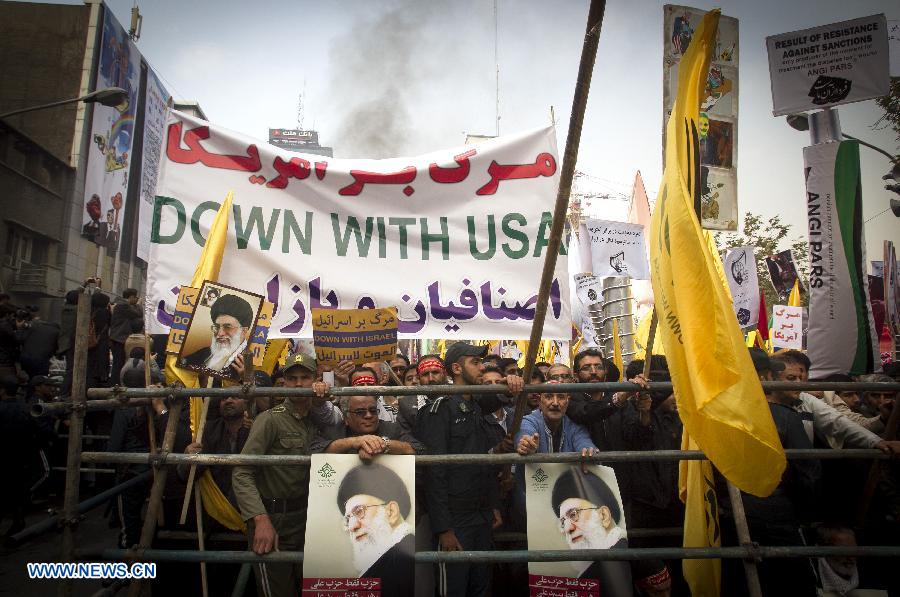 Iranian demonstrators take part in a rally marking the 34th anniversary of the seizure of the U.S. Embassy outside the former U.S. embassy in downtown Tehran, capital of Iran, on Nov. 4, 2013. Tens of thousands of Iranians held demonstrations on Monday across the country to mark the 34th anniversary of the seizure of the U.S. embassy in Tehran. 