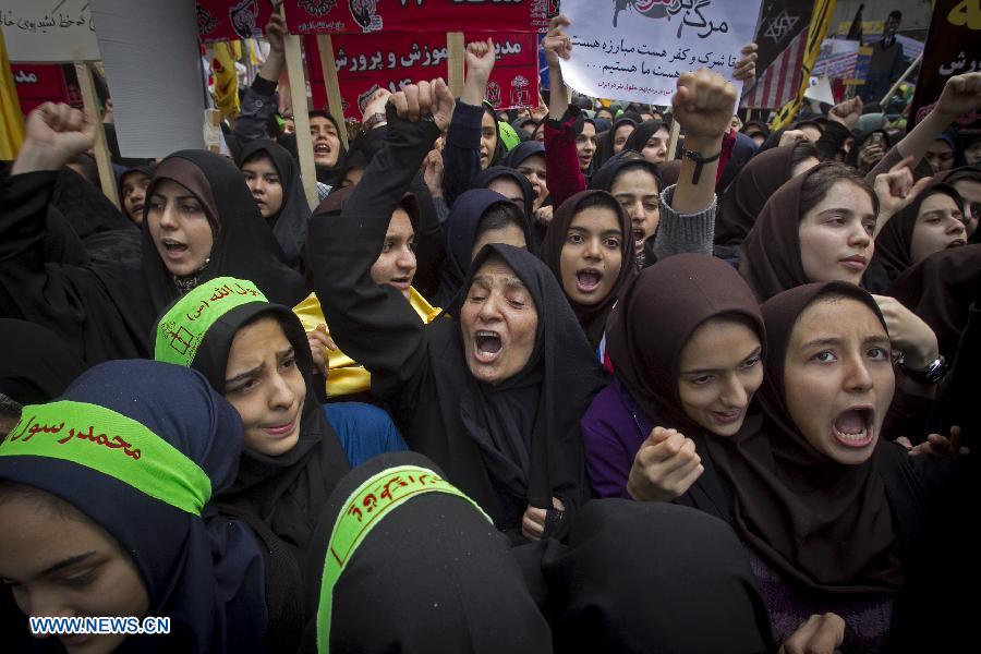 Iranian demonstrators shout slogans during a rally marking the 34th anniversary of the seizure of the U.S. Embassy outside the former U.S. embassy in downtown Tehran, capital of Iran, on Nov. 4, 2013. Tens of thousands of Iranians held demonstrations on Monday across the country to mark the 34th anniversary of the seizure of the U.S. embassy in Tehran.