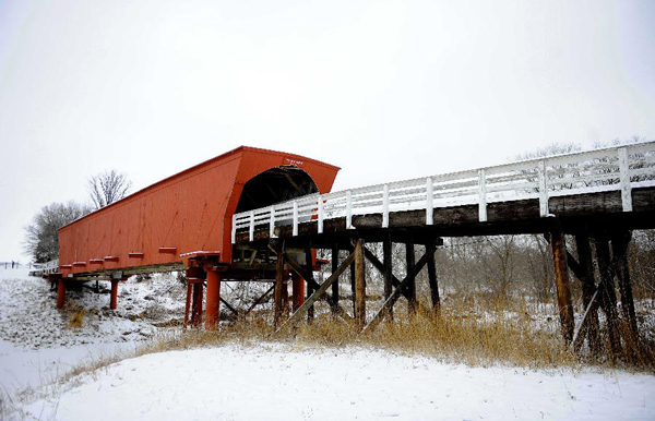 The Roseman Covered Bridge is covered with snow in Winterset, Iowa, the United States, Feb. 13, 2012. More than a decade after the movie 'The Bridges of Madison County' was released, thousands of people still travel to Winterset each year to trace the steps where Clint Eastwood and Meryl Streep immortalized the area's covered bridges. [Photo: Xinhua/Shen Hong] 