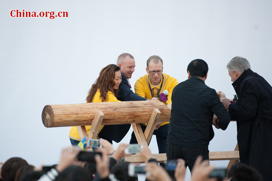 People saw a log, an IKEA tradition, to mark the launch of IKEA&apos;s second store in Beijing, China on Thursday morning. [Photo / Chen Boyuan / China.org.cn]