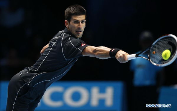 Novak Djokovic of Serbia returns the ball during the Singles Group B match against Juan Martin del Potro of Argentina on day 4 of the Barclays ATP World Tour Finals at the O2 Arena in London, Britain, Nov. 7, 2013. Novak Djokovic won 2-1. (Xinhua/Wang Lili)