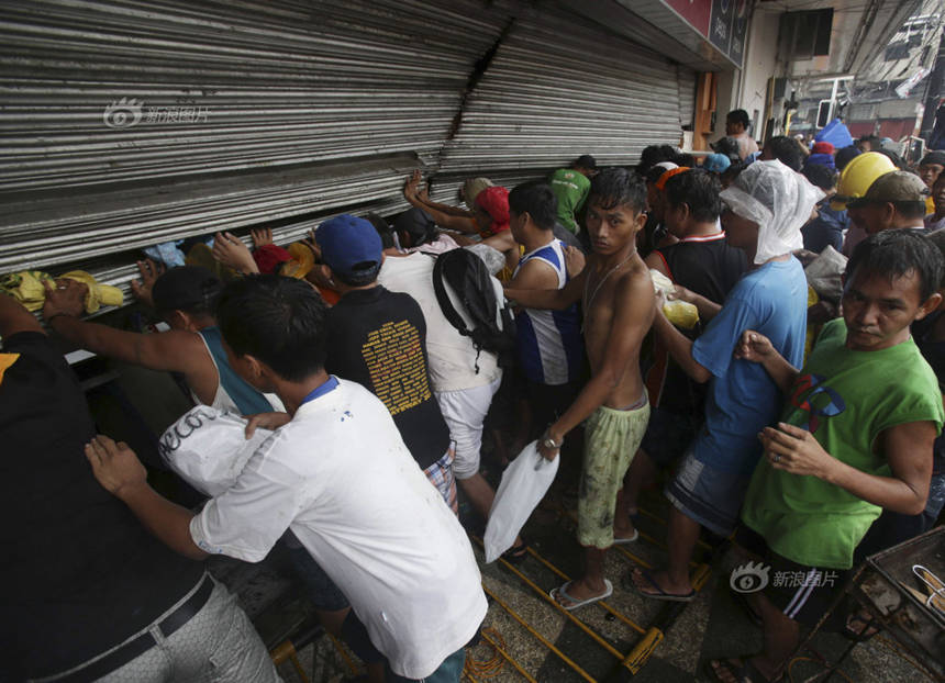 People loot a store after Typhoon Haiyan hits Tacloban City, the Philippines, on Nov. 10, 2013. The Leyte Provincial Governor has said that according to statistics provided by various sources, the typhoon is estimated to have left more than 10,000 people dead. 