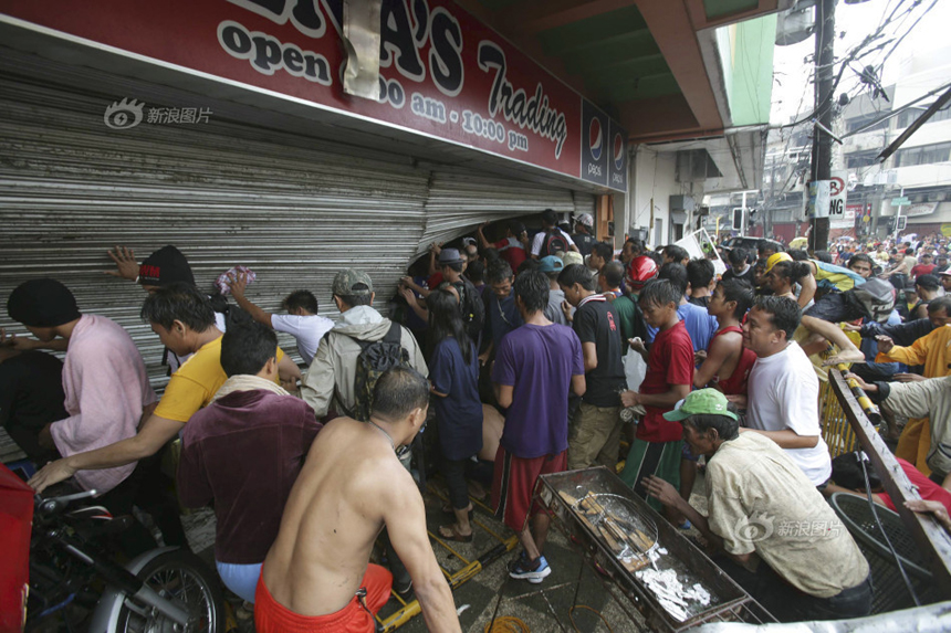 People loot a store after Typhoon Haiyan hits Tacloban City of Leyte Province, the Philippines, on Nov. 10, 2013. 