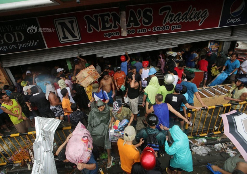 People loot a store after Typhoon Haiyan hits Tacloban City of Leyte Province, the Philippines, on Nov. 10, 2013. 
