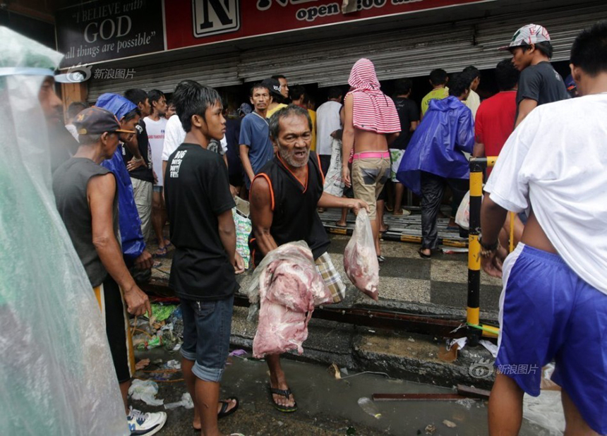 People loot a store after Typhoon Haiyan hits Tacloban City of Leyte Province, the Philippines, on Nov. 10, 2013. 