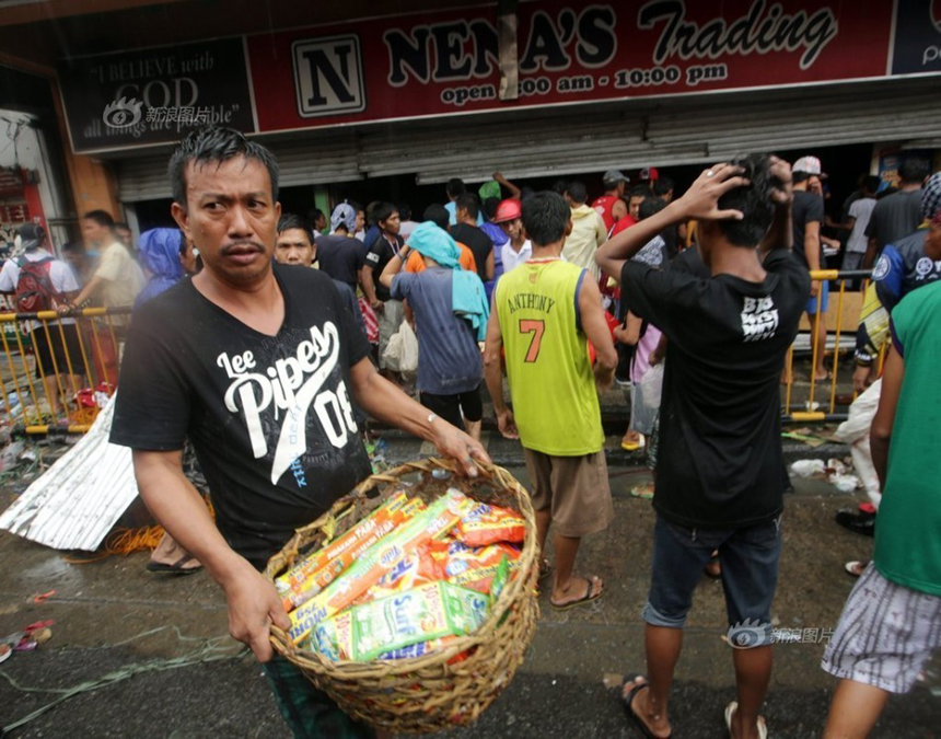 People loot a store after Typhoon Haiyan hits Tacloban City of Leyte Province, the Philippines, on Nov. 10, 2013. 