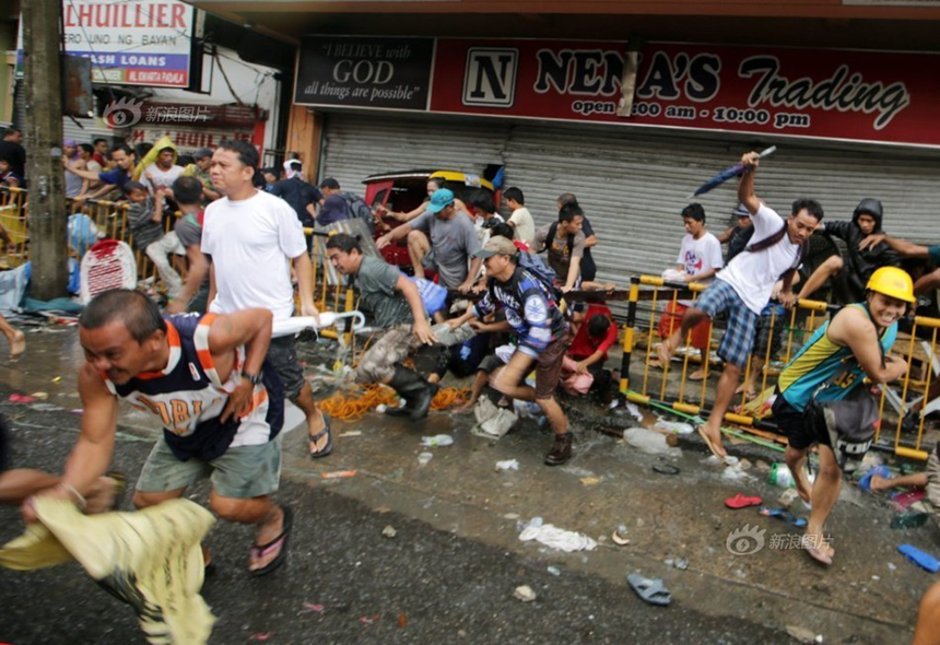 People loot a store after Typhoon Haiyan hits Tacloban City of Leyte Province, the Philippines, on Nov. 10, 2013. 