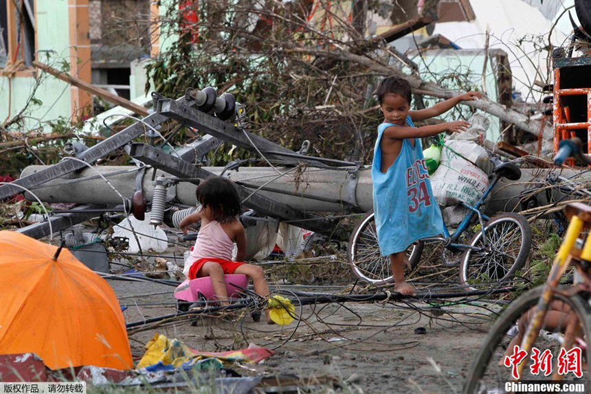 Children are frolicking about in the ruins after Typhoon Haiyan hits Tacloban City, the Philippines, on Nov. 9, 2013.