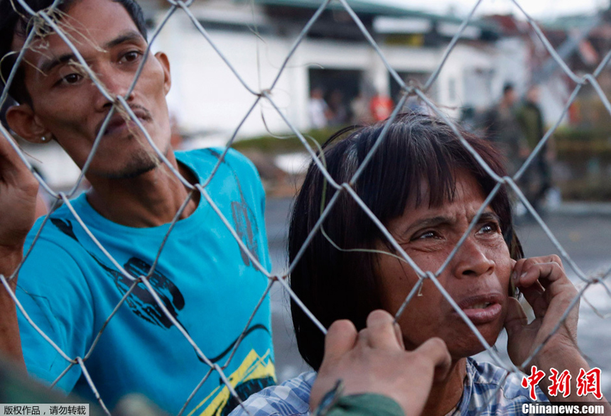 People are waiting for rescure after Typhoon Haiyan hits Tacloban City, the Philippines, on Nov. 9, 2013. 