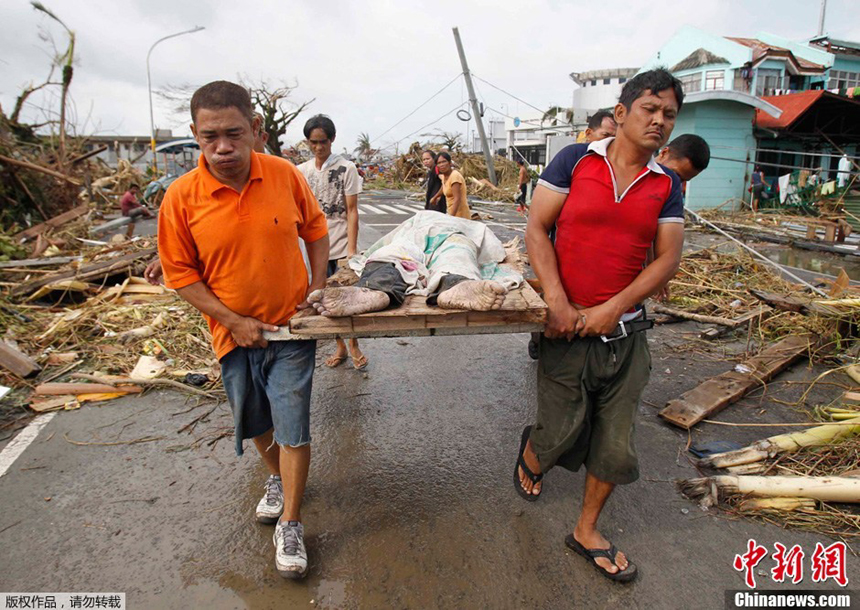 People are transporting a victim’s body after Typhoon Haiyan hits Tacloban City, the Philippines, on Nov. 9, 2013. 