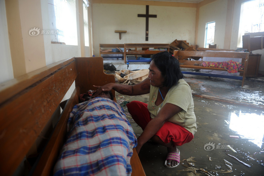 A mother is crying over her son’s body inside a church after Typhoon Haiyan hits Tacloban City, the Philippines, on Nov. 9, 2013. 