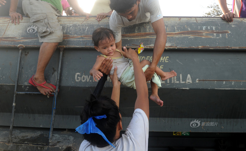 People return to their homes from the temporary shelters after Typhoon Haiyan hits Tacloban City, the Philippines, on Nov. 9, 2013. 