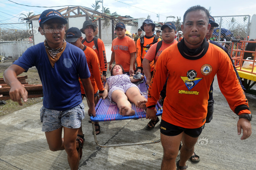 Rescue workers are moving a pregnant woman to a temporary hospital after Typhoon Haiyan hits Tacloban City, the Philippines, on Nov. 9, 2013. 