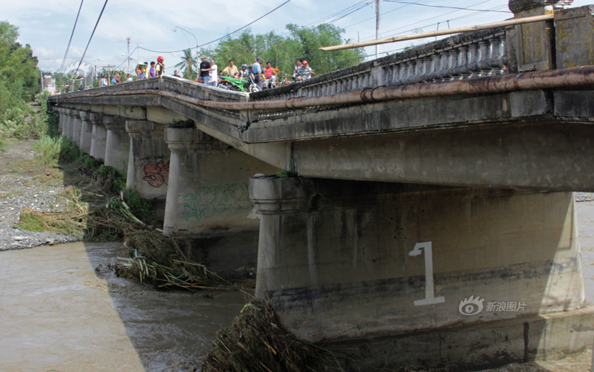 Typhoon Haiyan hits Iloilo City, the Philippines, on Nov. 9, 2013. People are seen checking a local bridge destroyed by the typhoon. 