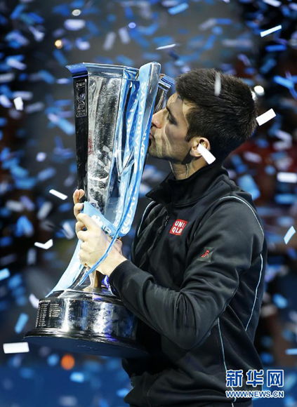 Sealed with a kiss: Djokovic shows his latest trophy some affection.