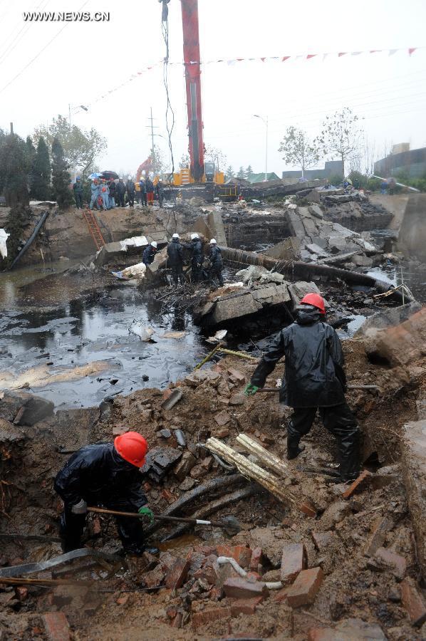 Workers are seen at the site of a pipeline explosion in Qingdao Development Zone, in Qingdao, east China's Shandong Province, Nov. 24, 2013. A leaking pipeline caught fire and exploded on Friday morning in Qingdao. The death toll in the explosion rose to 52 and the search effort is still ongoing. [Xinhua]