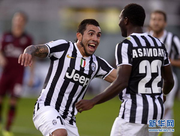 Carlos Tevez celebrates with Kwadwo Asamoah after scoring the second for Juventus.