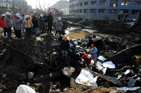 Technicians check a broken pipeline at the explosion site after a leaking pipeline caught fire and exploded in the Huangdao District of Qingdao, a coastal city in east China's Shandong Province, Nov. 25, 2013. The death toll from last Friday's oil pipeline blasts rose to 55 as of Monday. The blasts also left nine people missing and 136 others injured. [Xinhua]
