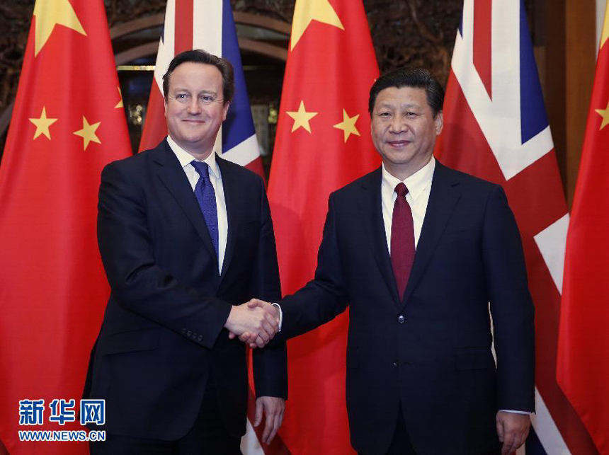 Chinese President Xi Jinping (R) shakes hands with visiting British Prime Minister David Cameron during their meeting in Beijing, capital of China, Dec. 2, 2013.(